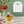 Load image into Gallery viewer, A hand with teal nail polish holds a tea bag above a glass teacup on a marble surface, with a green wall and leafy plant in the background. A white text panel on the right reads '100% Microplastic-Free Tea Bags' with bullet points about unbleached paper, stitched not glued, and organic cotton thread.
